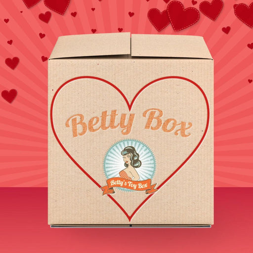 Betty's Kinky Kitties Mystery Box - Valentine's 2026 Edition features a large red heart outline with “Betty Box” on the front, a retro-style woman logo reading “Betty’s Toy Box,” and a pink background scattered with red hearts.