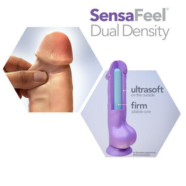 The image showcases a promo for a product called the "Big Daddy 14 Inch Dual Density Suction Cup Dildo - Vanilla" by Blush. It features a lifelike, dual-density dildo held between thumb and index finger, emphasizing its ultrasoft exterior with an internal diagram highlighting a firm, pliable core. This version is also compatible with strap-on fun capabilities.