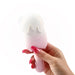 A hand with long pink nails holds the Bite Me Sucking Tapping & Vibrating Cream Pop Vibe, a small pink and white clitoral vibrator shaped like an ice cream popsicle.