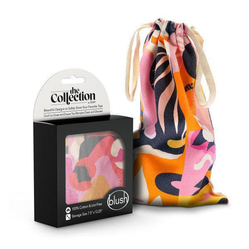 A product photo showcasing the Blush Burst Colorful Toy Storage Bag, a vibrant multicolored drawstring bag with abstract patterns, perfect as a cotton toy bag. Accompanying the bag is a black box labeled "The Collection" and "Blush." The box features a small window displaying the matching pattern of the machine washable drawstring bag and states it's 100% cotton.