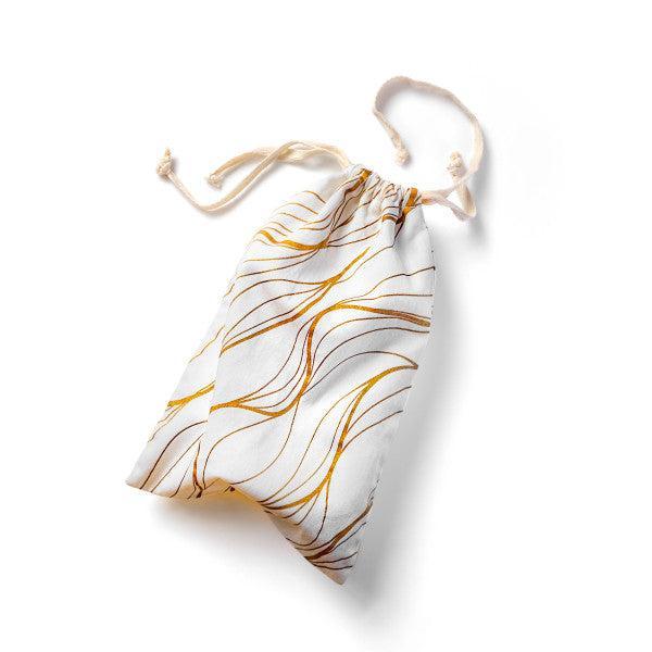 Introducing the Blush Embrace White & Gold Toy Storage Bag by Blush. This stylish, machine-washable drawstring bag features a white base adorned with an abstract, wavy pattern in gold and brown. The secure top closure with tied drawstrings makes it perfect for storing your sex toys. Photographed against a plain white background, this bag combines functionality with elegance.