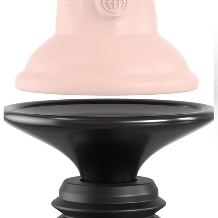 Close-up of a two-piece object, one part being a smooth, light pink featureless ring or cap with a globe logo, and the other part being a black, shaped base with ridged edges reminiscent of the Body Dock Thruster Powerful Thrusting Suction Cup Sex Toy Mount. The pieces are separated and aligned vertically facing each other.