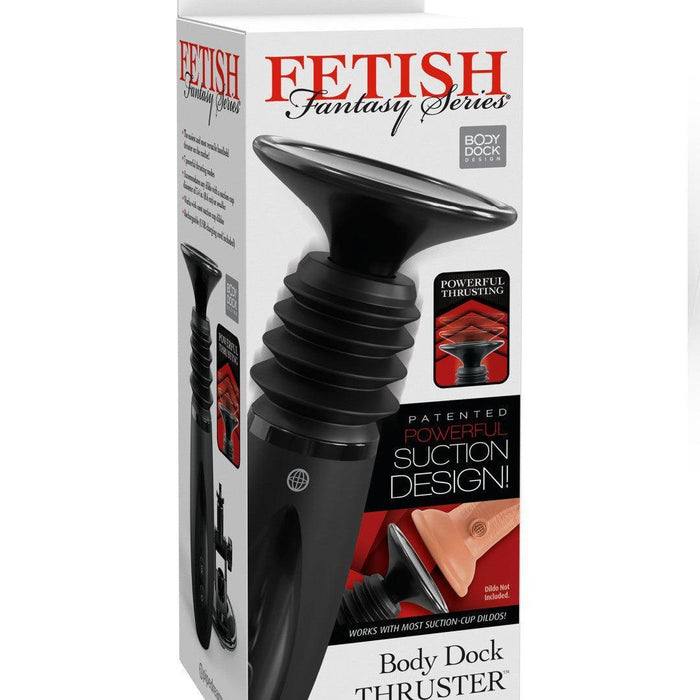 Box of "Body Dock Thruster Powerful Thrusting Suction Cup Sex Toy Mount" by Pipedream Products in white packaging with red and black text. The product image features a sleek black suction cup dildo thruster. Descriptions highlight its powerful thrusting capabilities, patented suction design, and compatibility with various suction cup dildos.
