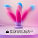 A photo of the Borealis Dreams 7.75 Inch Girthy Silicone Dildo - Cotton Candy by Blush, featuring a pastel-colored design with hues of pink, blue, and purple. The dildo has a three-pronged structure and comes with a strong suction cup base for hands-free pleasure and play. The background is shaded in light pink and purple.