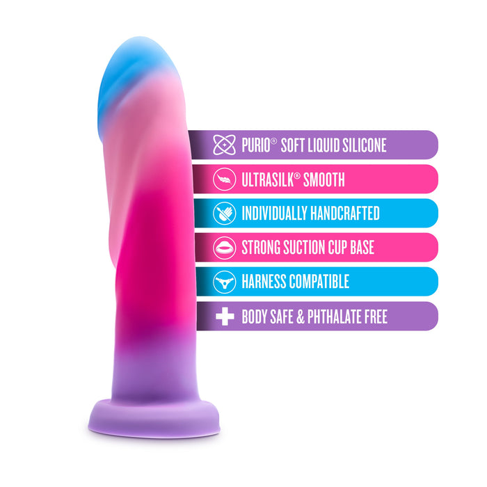 An image of the Borealis Dreams 7.75 Inch Girthy Silicone Dildo - Cotton Candy by Blush, showcasing its vibrant gradient pattern in pink, blue, and purple. It features Purio soft liquid silicone, an Ultrasilk smooth finish, is individually handcrafted with a strong suction cup base for versatile use, offers G-spot stimulation design, and is body safe & phthalate free.