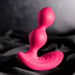 The Evolved Novelties Bubble Butt Inflatable Vibrating Butt Plug with Remote, a pink, body-safe silicone sex toy with a contoured, ergonomic design featuring two bulbous sections and a curved base, is placed against a dark, silky background.