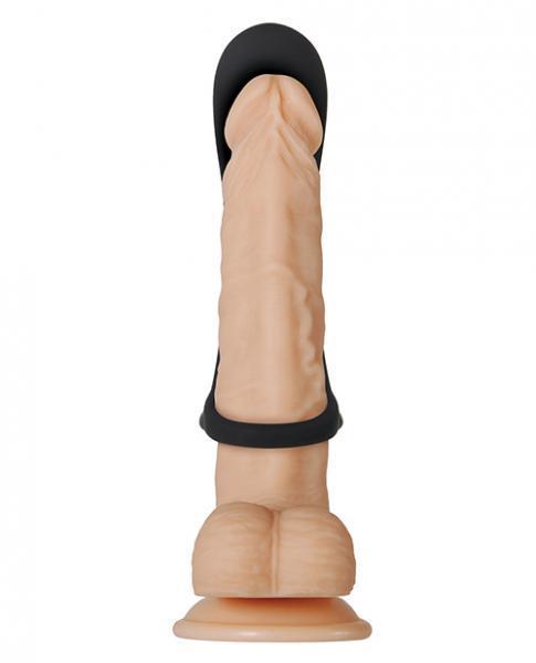 The Cock Armor Vibrating Black Cock Ring and Penis Support by Evolved Novelties features a realistic-looking beige dildo, intricately detailed with veins and ridges. It includes a black harness-like strap around the base, crafted from high-quality silicone. Standing upright on a round suction cup base, it is designed to adhere securely to smooth surfaces for convenient hands-free use.