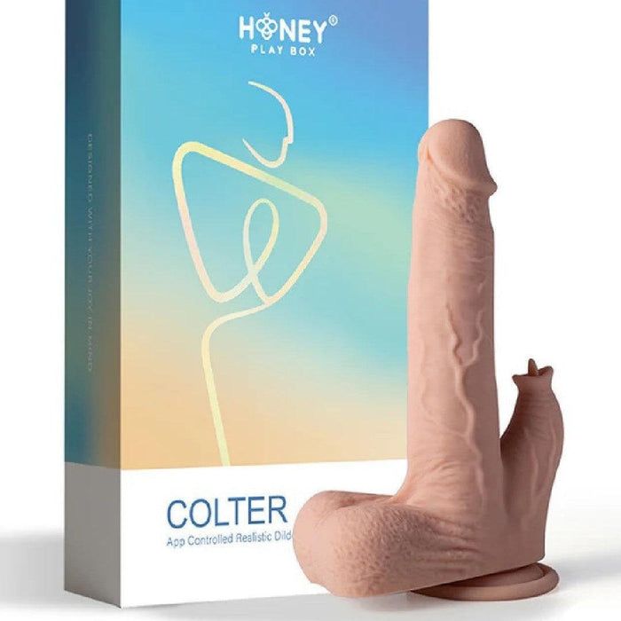 Product image featuring a box labeled “Colter Thrusting Large 8.5" Realistic App Controlled Dildo with Clit Licker” next to a beige, phallic-shaped adult toy designed for sexual stimulation.