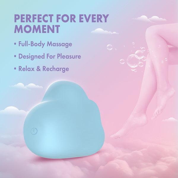 The Cuddle Cloud External Palm Sized Vibrator, a blue cloud-shaped silicone toy, rests on pink clouds beneath a pastel sky. Text: "Perfect for every moment – Full-body massage, Designed for pleasure, Relax & recharge." Floating legs and bubbles nearby.