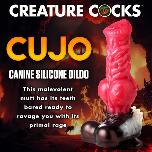 A promotional image showcasing the Cujo Canine Werewolf Silicone Dildo with Knot from XR Brands. This silicone dildo features a striking red, textured design with exaggerated details and stands on a distinctive paw-shaped base. Strapon-harness compatible, it is set against a fiery, ominous backdrop and includes vivid descriptions of the product.