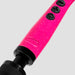 A close-up of the Doxy Die Cast 3 Compact Wand Vibrator in Hot Pink showcases its vibrant pink glittery handle, complete with black buttons and a textured black grip at the base. The image highlights the small Doxy brand logo imprinted on its body-safe silicone handle, all set against a plain white background.