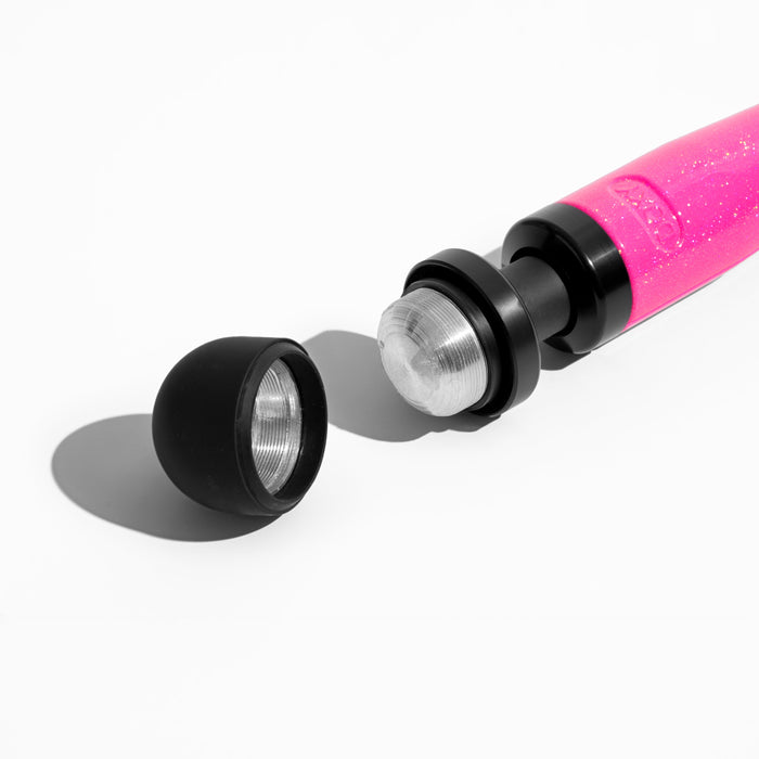 A close-up of the Doxy Die Cast 3 Compact Wand Vibrator in Hot Pink on a white background. The body-safe silicone head is detachable, and the cap lies next to it, revealing the internal metal components designed for targeted intensity and massage therapy. This compact powerhouse by Doxy elevates your relaxation experience.
