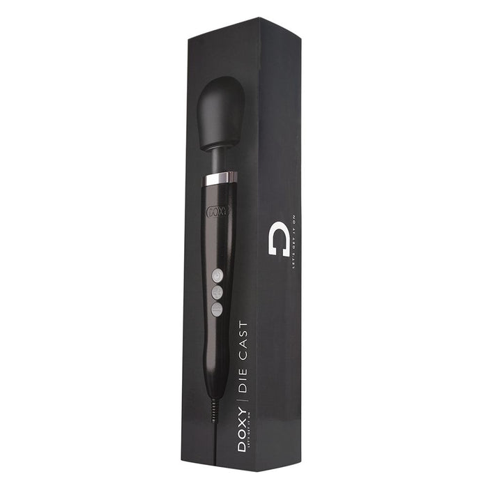 An image of a boxed Doxy Die Cast Extra Powerful Wand Vibrator - Black. The sleek packaging is primarily black with a white logo and text, showcasing a photo of the luxurious wand vibrator from Doxy. The massager features a rounded head, three control buttons, and a cord for power, promising deep rumbly vibrations.