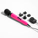 The Doxy Die Cast Extra Powerful Wand Vibrator in Hot Pink, known for its deep rumbly vibrations and featuring a black rounded head with a power cord, is laid out on a white surface alongside five black plug adapters and a black power adapter.