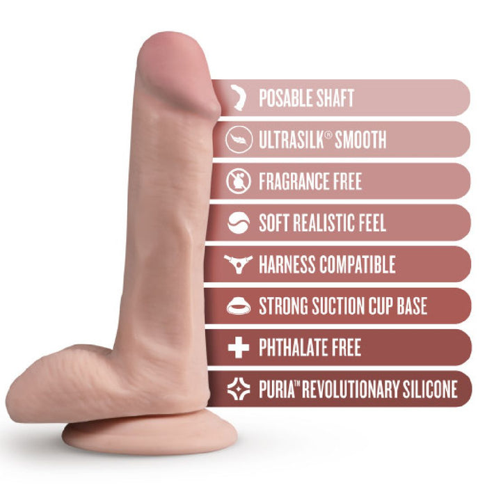 A Blush Dr. Daniel 6 Inch Beginner Suction Cup Dildo - Vanilla is shown with descriptive labels to the right. The labels highlight features, including a posable shaft, Ultrasilk smoothness, fragrance-free, soft realistic feel, harness compatibility, strong suction cup base, phthalate-free material, and Puria™ platinum cured silicone.