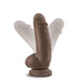 Image of the Dr. Skin Girthy Short Thick Dildo in Chocolate, made from brown silicone with a suction cup base. The dildo stands upright, with overlays showing its thick, flexible design and side-to-side bending capability.