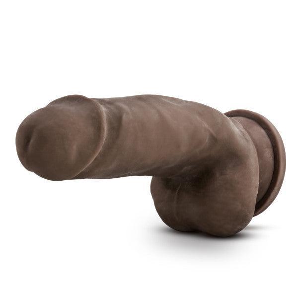 The Dr. Skin Girthy Short Thick Dildo in Chocolate features a realistic design with a defined head and testicles, made from brown silicone, and includes a suction cup base for harness compatibility or hands-free use, shown on a white background.