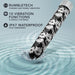 A black vibrating wand, adorned with white floral designs, is partially submerged in water with splashes around it. Text on the left reads: "Blush - Powerful deep rumbly vibrations," "10 Vibration Functions (5 speeds, 5 patterns)," and "IPX7 Waterproof - Fully submersible." Introducing the Eden Black Floral Slim Beginner Bullet Vibrator.