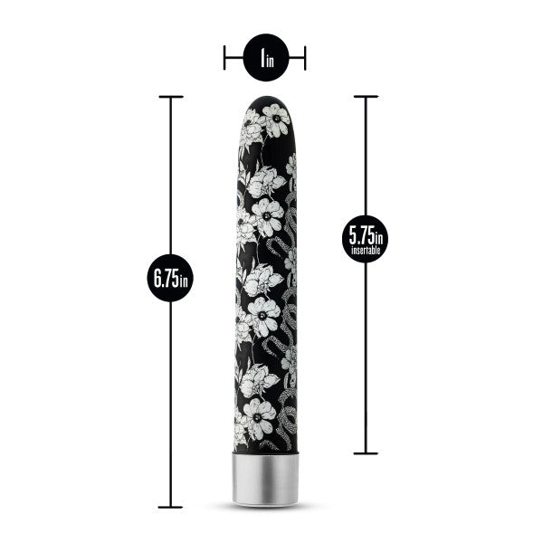 The Eden Black Floral Slim Beginner Bullet Vibrator by Blush features a long, black, cylindrical design adorned with white floral patterns. It measures 6.75 inches in length with an insertable length of 5.75 inches and a width of 1 inch. The silver base complements its powerful vibration modes and submersible waterproof design.