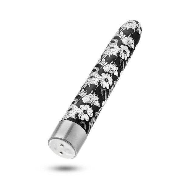 The Eden Black Floral Slim Beginner Bullet Vibrator by Blush, showcased against a white background, features a sleek black design adorned with white floral patterns and a silver cap. Its tapered end and rounded tip provide an ergonomic touch, while its submersible waterproof capabilities and powerful vibration modes ensure enhanced pleasure.