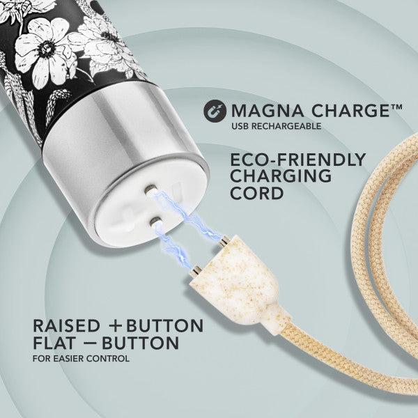 An image displaying a close-up of the Blush Eden Black Floral Slim Beginner Bullet Vibrator, highlighting its submersible and USB rechargeable design with a floral pattern near the charging port. The eco-friendly charging cord features a magnetic connection with visible blue sparks. Labels indicating "Magna Charge" and both raised and flat control buttons are present.