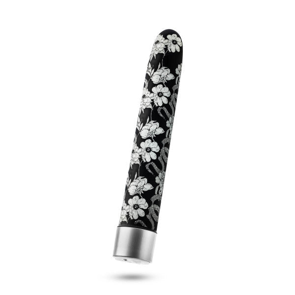 The Eden Black Floral Slim Beginner Bullet Vibrator by Blush is a small, elongated, cylindrical object with a smooth, rounded tip, decorated with a black and white floral design. This classic slimline vibrator features a silver base and boasts a sleek, modern design.