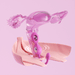 A digitally rendered image displays the Elektra App-Controlled E-Stim Kegel Training Set for Pelvic Floor—a purple exerciser placed in a transparent pink uterus illustration above a stylized pelvic floor, with vibration lines and a light pink background.
