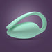 The Elvie Trainer Smart Kegel Exerciser, a mint green, oval-shaped device with a curved handle and "elvie" branding, is shown on a purple gradient background. Its design is sleek and modern.