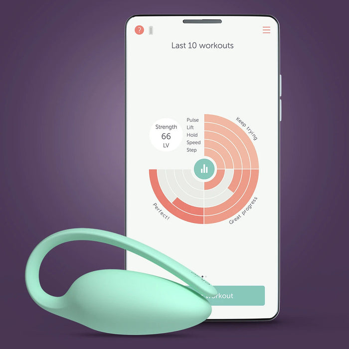 The Elvie Trainer Smart Kegel Exerciser in mint green sits in front of a smartphone displaying workout stats and pelvic floor strength summaries on its app, all set against a purple background.