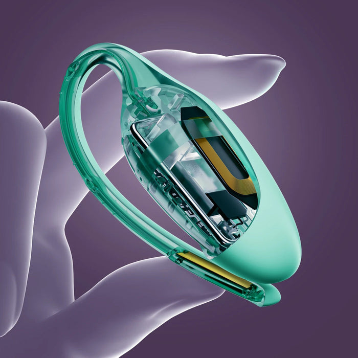 A hand holds an Elvie Trainer Smart Kegel Exerciser, its translucent green body revealing intricate electronics, set against a purple background.