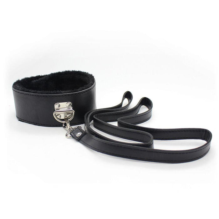 The Ple'sur Everything Bondage 9 Piece Beginner's Bondage Kit - Black features a black faux leather collar with a metal buckle and furry lining, delivering a sensory thrill, attached to a long black leash. The collar and leash are beautifully arranged on a white background.