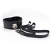 The Ple'sur Everything Bondage 9 Piece Beginner's Bondage Kit - Black features a black faux leather collar with a metal buckle and furry lining, delivering a sensory thrill, attached to a long black leash. The collar and leash are beautifully arranged on a white background.