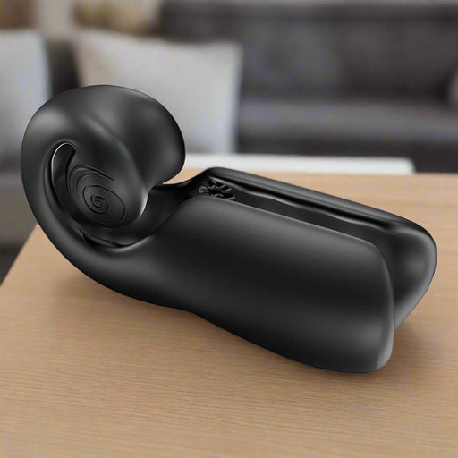 A sleek, black, futuristic Evo Rolling Penis Masturbator with head & shaft vibrations, shaped like a reclining form with smooth curves and a spiral detail on one side, crafted from medical-grade silicone.