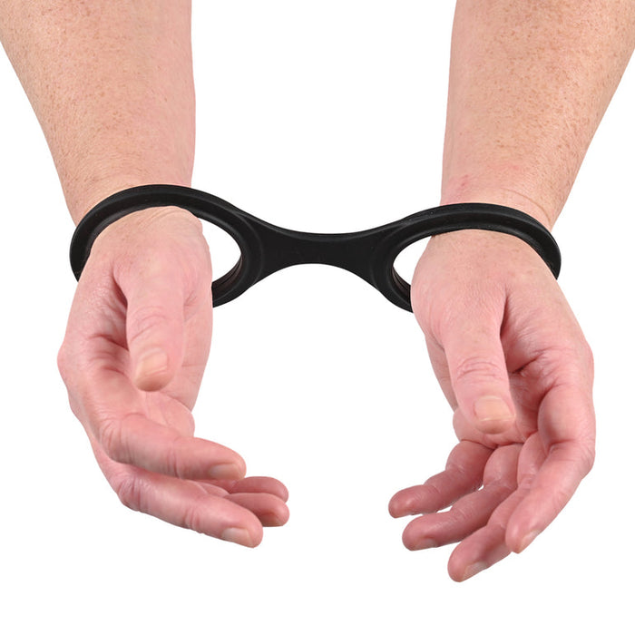 A pair of hands with wrists restrained by the black plastic cuffs from the Ex's & Oh's Kiss Kit - 4 Piece Beginner Bondage Kit, palms facing upward and forearms extended forward.