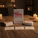 The "Extreme Personal Questions for Lovers" card game box rests on a wooden table surrounded by cards and candles, setting a romantic vibe—an ideal pick for an intimate card game or unforgettable date night.