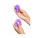 Two hands holding the Fantasy For Her Remote Controlled Kegel Exerciser by Pipedream Products. The top hand holds the bullet-shaped device, designed for discreet vibration, while the bottom hand grips the remote control with a button, with the thumb pressing down on it.