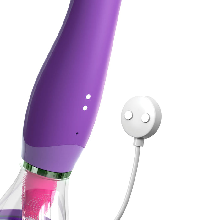 The Fantasy For Her Ultimate Pleasure Double Ended Tongue Vibrator by Pipedream Products features a sleek, purple design with a clear bottom container housing a pink component. It comes with an ergonomic, modern look and includes a white two-button control device attached via a cord, making it perfect for clitoral stimulation.