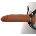 The Fantasy X-Tensions Elite Hollow 8 Inch Silicone Dildo & Strap-On Harness - Chocolate by Pipedream Products showcases a lifelike brown dildo complete with an attached harness strap. The design features secure metal rings and a dual-density construction. Part of the harness can be seen, suggesting it is worn around the waist or pelvis area, set against a white background.