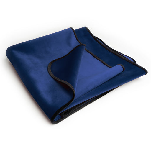 A neatly folded Liberator Fascinator Travel Sized Waterproof Sex Blanket in royal blue with black trim is displayed on a white background.