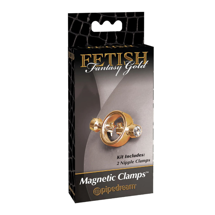 A black and gold package labeled "Fetish Fantasy Gold Magnetic Nipple Clamps with Diamond Tips" by Pipedream Products. The box displays a product image of two polished gold magnetic nipple clamps adorned with small faux diamonds. Text indicates the kit includes 2 nipple clamps. The background features a metallic design.