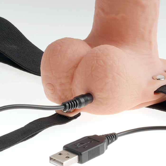 The Fetish Fantasy Vibrating 11 Inch Hollow Dildo with Balls and Strap-on Harness in vanilla offers a realistic design, skin-like texture, USB connectivity, and adjustable black straps, providing comfort and functionality for all users.
