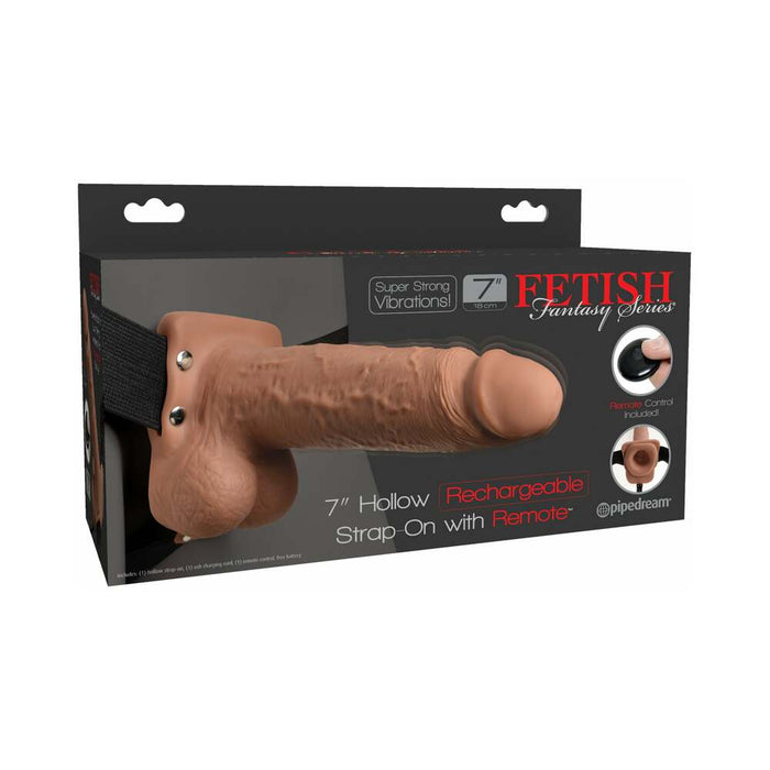 Here is a product image of the Fetish Fantasy Vibrating 7 Inch Hollow Dildo with Balls and Strap-on Harness with Remote by Pipedream Products. The package displays a caramel-colored, realistically designed 7-inch hollow dildo, complete with an elastic harness. It features powerful vibrations and is rechargeable. The set also includes a remote control.