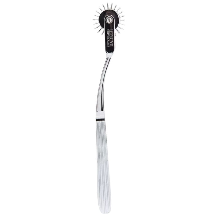 A stainless steel Fifty Shades Darker Adrenaline Spikes Metal Wartenberg Pinwheel featuring a curved handle and a rotating head with evenly spaced, pointed pins at the end. The grooved texture on the handle ensures grip, while "Lovehoney" is engraved on the hypoallergenic sensory toy for added detail.