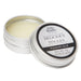 A small open tin from the Fifty Shades of Grey Desire Blooms Kit reveals creamy balm for clitoral stimulation, with its labeled lid resting beside it.