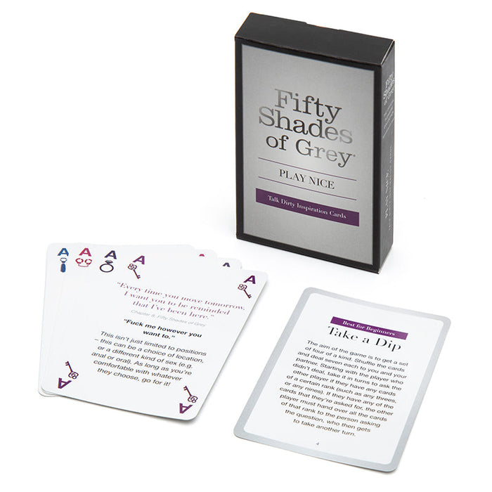 A box labeled "Fifty Shades of Grey Play Nice Talk Dirty Inspiration Cards" sits beside several cards spread out, each featuring suggestive prompts for dirty talk, role play, and other intimate activities.