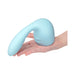 A hand holds the Flexi Posable Silicone Wand Attachment—a light blue, curved silicone accessory with a smooth, bulbous end and elongated shape for internal and external wand massager stimulation.