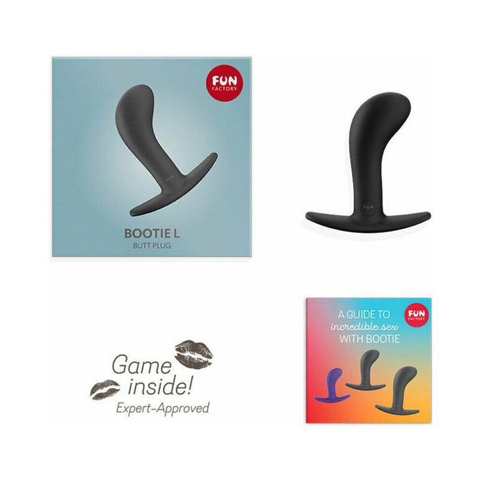 An image of the packaging and contents of the "Fun Factory Bootie Large Silicone Anal & Prostate Plug - Black." The packaging features the black silicone base, a slogan that reads "Game inside!" alongside lipstick marks, and a booklet titled "A guide to incredible prostate play with Bootie" from Fun Factory.