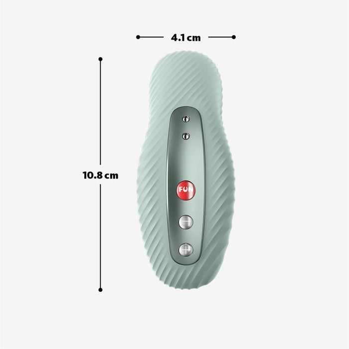 The Fun Factory Laya 3 Lay On Humping Vibrator in Sage Green is a green, vertically positioned device with ribbed edges and a central control panel featuring three buttons. Crafted from body-safe silicone, it measures 10.8 cm long and 4.1 cm wide. The middle button is red with "FUN" written on it, flanked by two smaller round buttons for easy operation.