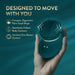 A hand holds the Riana Circular Clitoral Rubbing Vibrator, a compact, teal, palm-sized toy with a wavy top. Text highlights its ergonomic shape, seamless contouring, AutoRub technology, and one-button control on a teal background.