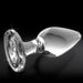 The Icicles No. 26 Clear Glass Butt Plug rests on a black background, its smooth and shiny borosilicate glass surface reflecting light—ideal for temperature play with its flared base for safety.